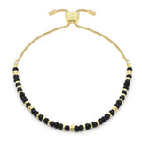 Introducing the BR: Mystical Black Spinel Gold bracelet from Benet Store, Inc.—an adjustable gold chain adorned with alternating small black spinel and gold beads, beautifully showcased on a white background. This elegant piece is perfect for adding a mystical touch of jewelry to any ensemble.