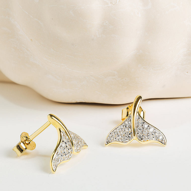 Shanore Gold Vermeil & White Sapphire Whale Tail Post Earrings are shown against a smooth, light-colored stone background.