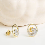 Shanore Gold Vermeil & White Sapphire Wave Post Earrings with swirl designs, featuring small white sapphires, displayed against a light, textured background.