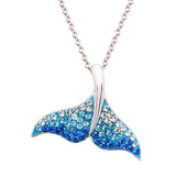 The Shanore Swarovski Crystals Blue/White Crystal Whale Tail Necklace features a sparkling pendant with blue and clear gems.