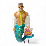 The December Diamonds Open House Ornament features a muscular merman with gray hair, sunglasses, open white shirt, neon green tie, and blue-scaled tail holding a For Sale Sold sign—a unique addition to your holiday or Merman decor.