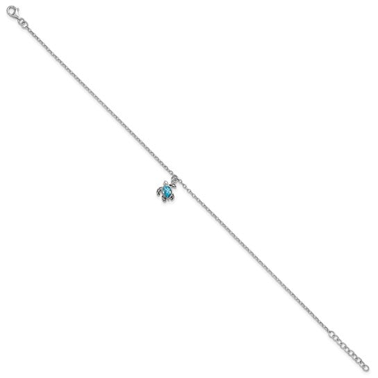 The Presco/Quality Gold Crystal Turtle Dangle Aqua Cry Anklet showcases a delicate sterling silver chain with a small turtle charm featuring an aqua crystal center, displayed against a white background.