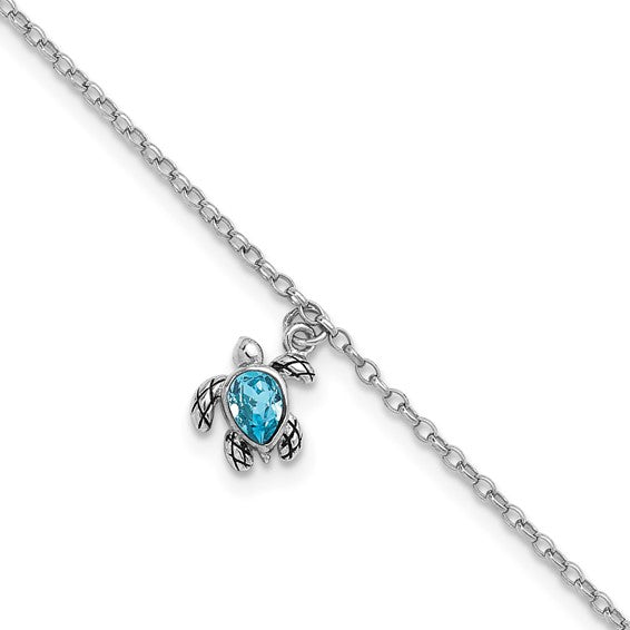 A silver chain necklace with a turtle pendant featuring a blue oval gemstone shell pairs beautifully with the Presco/Quality Gold Crystal Turtle Dangle Aqua Cry Anklet for a coordinated, charming look. The turtle’s head, legs, and tail are detailed in silver.