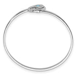 The Presco/Quality Gold Crystal Wave Bangle Bracelet is a thin sterling silver piece with a small oval clasp and a single light blue gemstone, offering a simple yet elegant, timeless jewelry design.