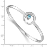 The Presco/Quality Gold Crystal Wave Bangle Bracelet features a sterling silver swirl design with a small blue gemstone and is shown on an inch ruler for size reference.
