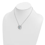 The Presco/Quality Gold Crystal Wave Aqua Crystal Pendant is a silver necklace with a circular pendant featuring a small blue crystal, displayed on a white jewelry bust.