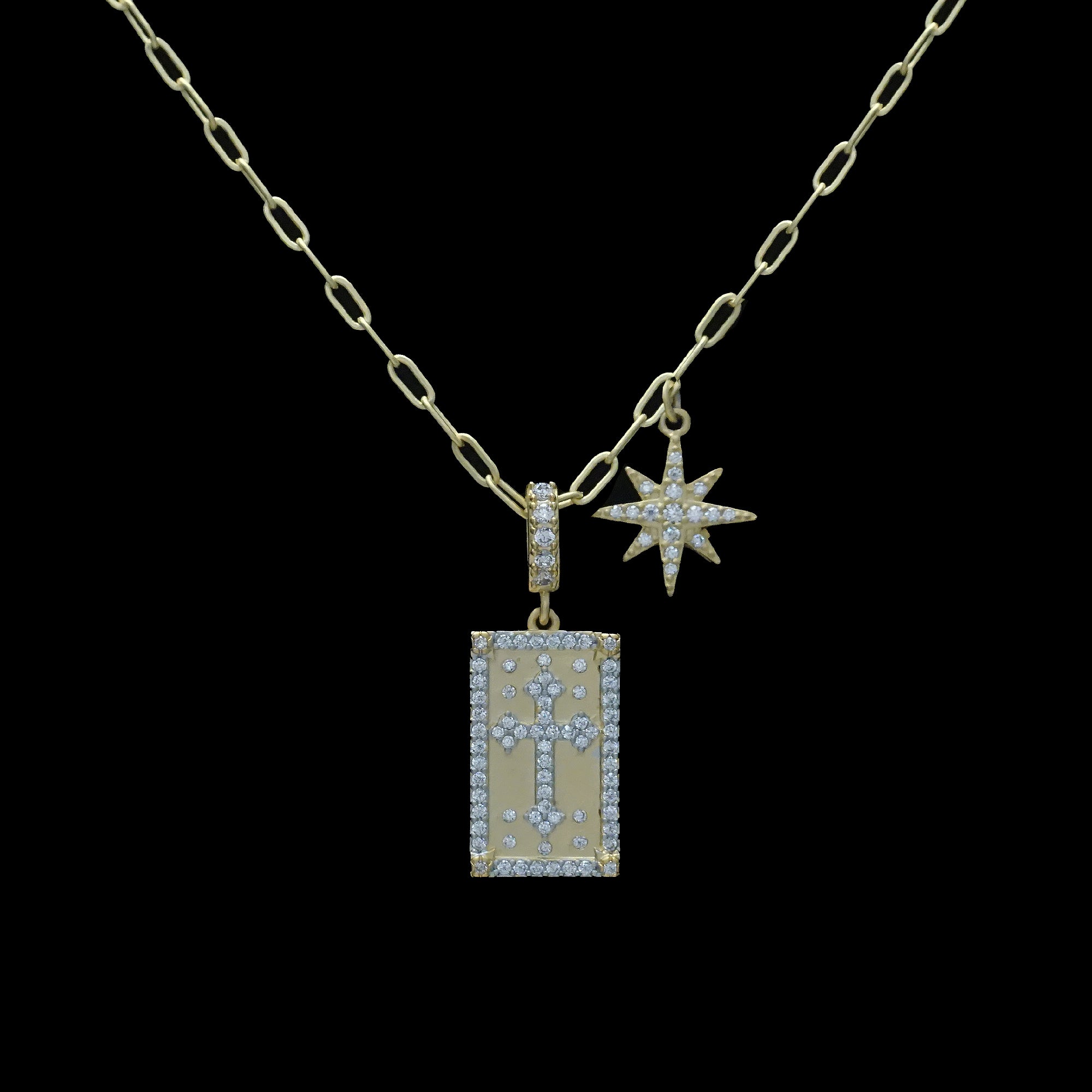 The Be-Je Designs Gold Pave CZ Starburst & Cross Necklace features sparkling pendants—a dazzling starburst and a shimmering cross—on an adjustable 14kt gold chain for timeless elegance.