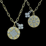 Two Be-Je Designs Gold Paperclip Reversible Disc Necklaces: one side features a pave flower, the other a star; both with diamond accents. 14kt gold chains, photographed on a black background.