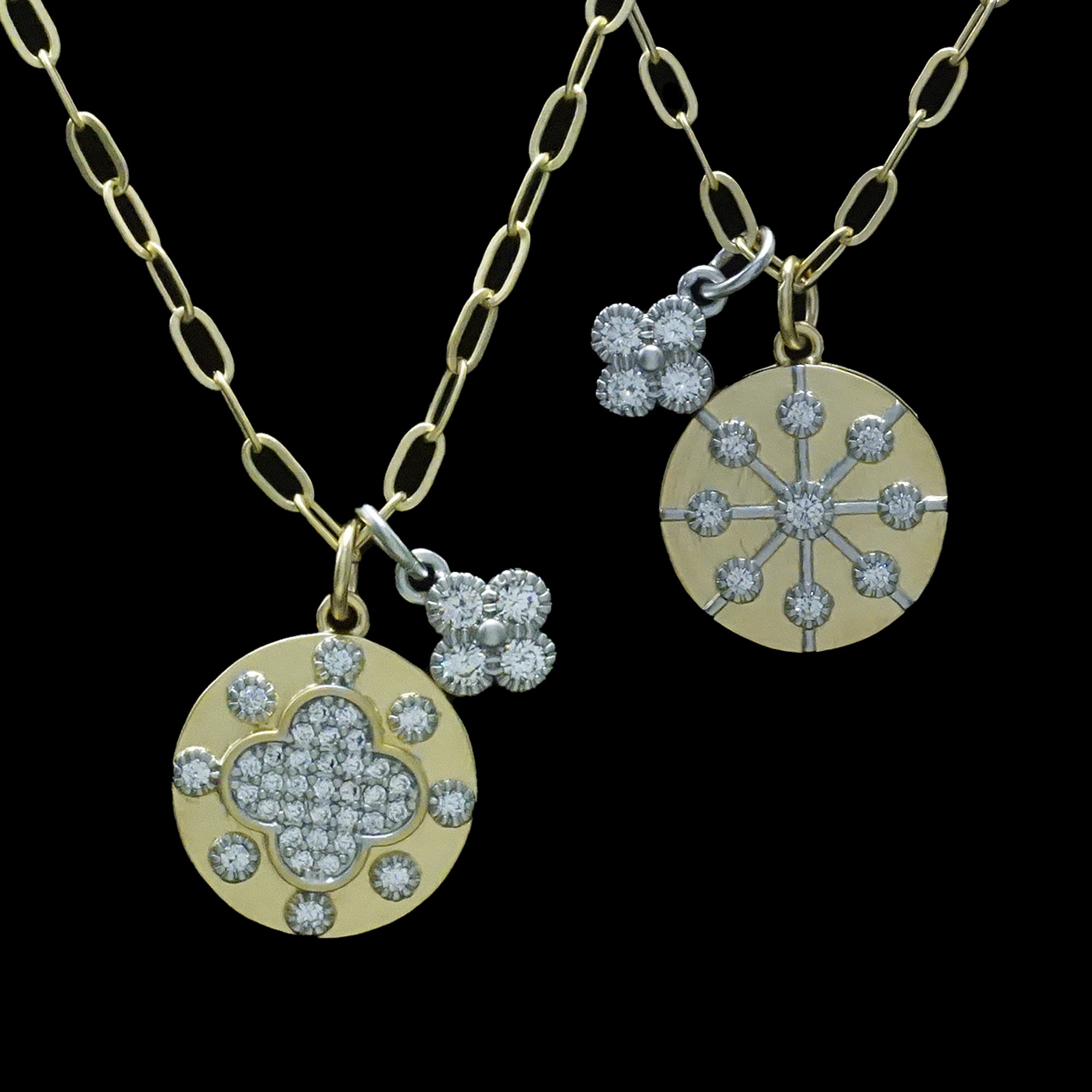 Two Be-Je Designs Gold Paperclip Reversible Disc Necklaces: one side features a pave flower, the other a star; both with diamond accents. 14kt gold chains, photographed on a black background.