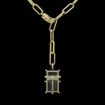 The Be-Je Designs Gold Paperclip Necklace features elongated links, a pave lobster claw, and a rectangular pendant with a stylized dragonfly design set against black cubic zirconia.