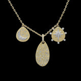 The Be-Je Designs Gold Teardrop Charms Star & Half Moon Necklace features three pendants—diamond moon and stars, diamond starburst, and an oval with cubic zirconia—on an adjustable 14kt gold chain.