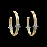 The Gold Pave Stars Hoop Earrings by Be-Je Designs feature handcrafted gold electroplating, a row of small diamonds, and a central star-shaped diamond accent, shown against a black background.
