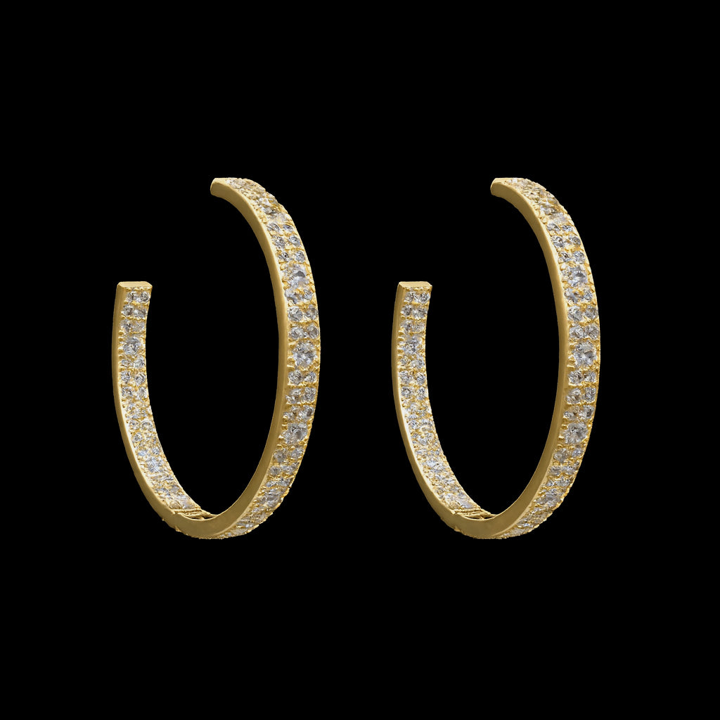 The Be-Je Designs Gold Pave Clear CZ Hoop Earrings feature sparkling cubic zirconia in 14kt gold, shown against a solid black background.