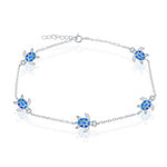 The Caribbean Opal Inlay Turtle Anklet by Classic of New York features five blue sea turtle charms with detailed flippers and patterned shells—a stylish sterling silver accessory perfect for beach lovers.