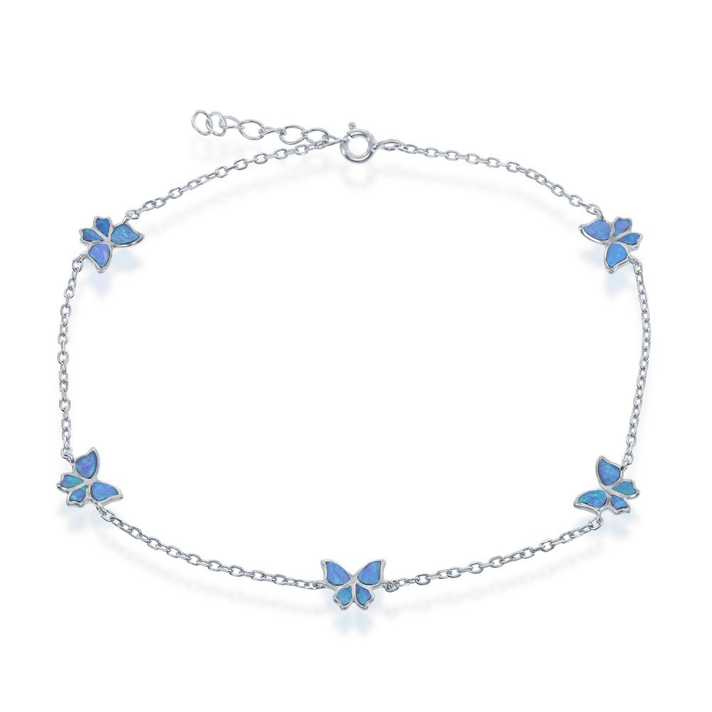 The Classic of New York Caribbean Opal Inlay Butterfly Anklet features five blue butterfly charms on a sterling silver chain with an adjustable clasp, inspired by Caribbean opal anklets—ideal for your beach jewelry collection.