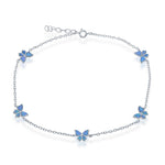 The Classic of New York Caribbean Opal Inlay Butterfly Anklet features five blue butterfly charms on a sterling silver chain with an adjustable clasp, inspired by Caribbean opal anklets—ideal for your beach jewelry collection.