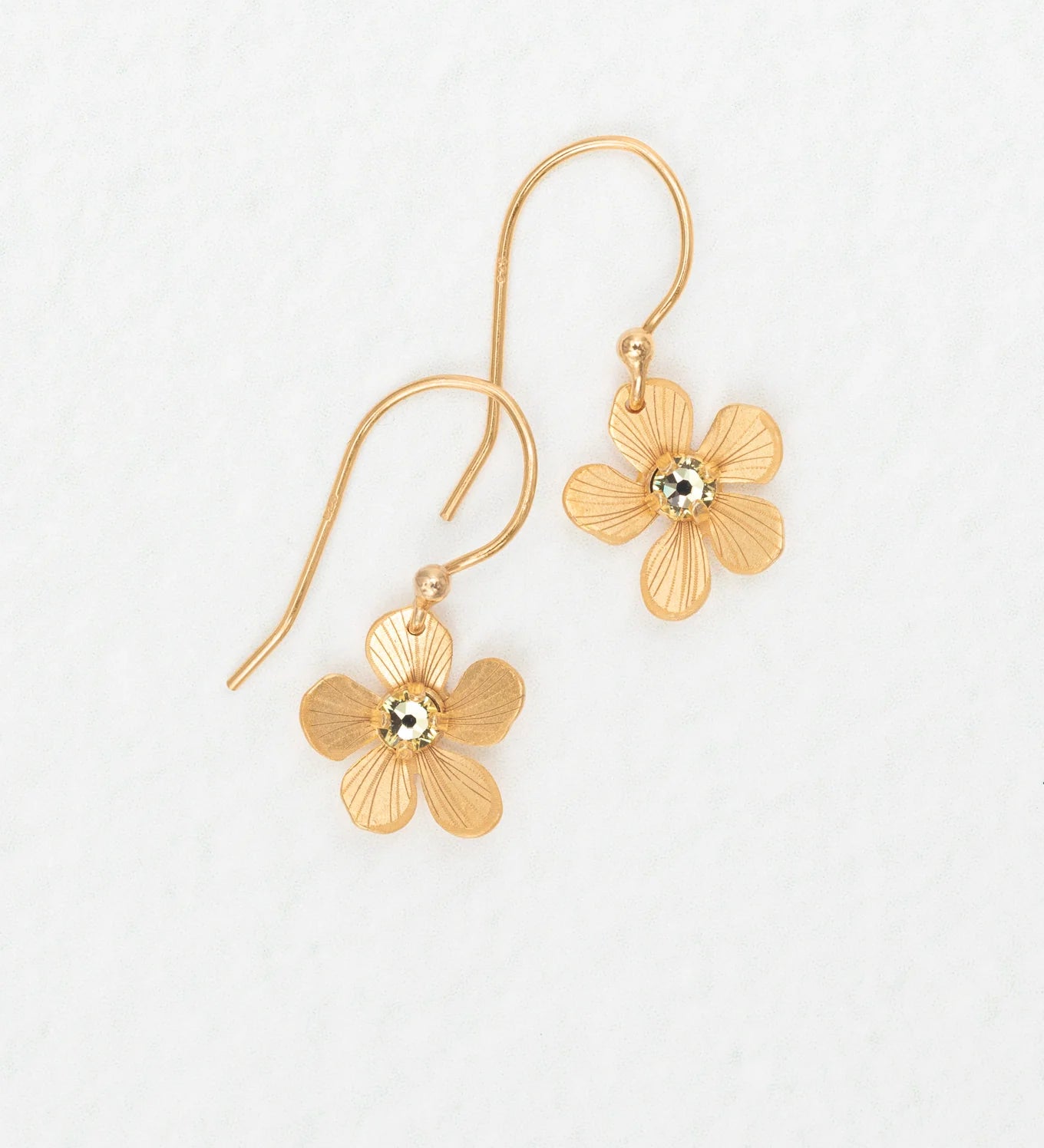 The Plumeria Drop Gold Earrings by Holly Yashi feature textured, flower-shaped petals with a shiny center—feminine jewelry perfect for garden parties. Displayed on a white background.