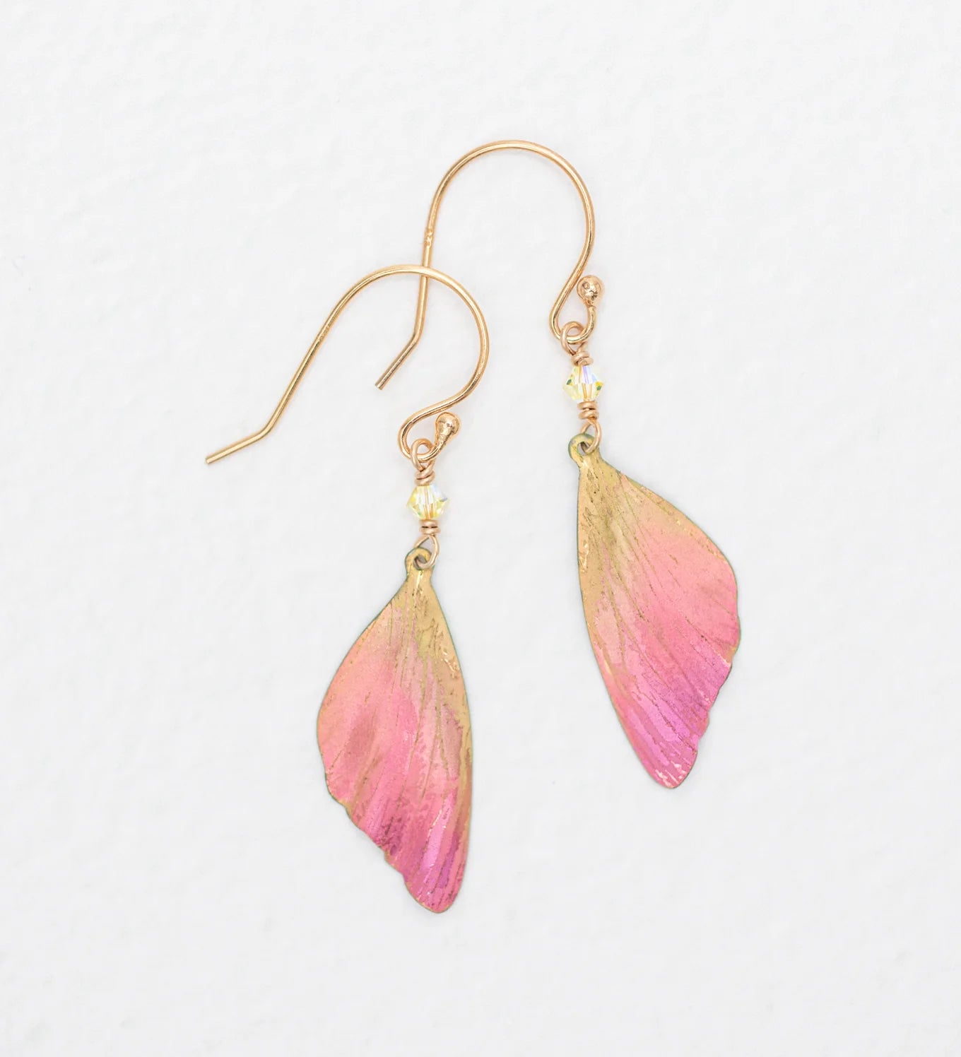 The Special Edition Flutterby Pink Earrings by Holly Yashi feature gold hooks and pink, butterfly wing-shaped charms with gold accents—ideal gold earrings to support cancer awareness. Shown on a white background.