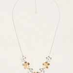 The Plumeria Classic Silver/Gold Necklace by Holly Yashi features a silver chain with five handcrafted floral pendants—three gold, two silver—in a V-shape and an adjustable clasp for the perfect fit.