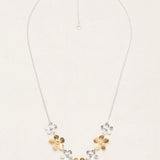 The Plumeria Classic Silver/Gold Necklace by Holly Yashi features a silver chain with five handcrafted floral pendants—three gold, two silver—in a V-shape and an adjustable clasp for the perfect fit.