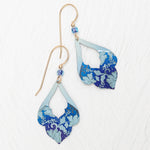The Marisol Forever Blue Earrings by Holly Yashi feature gold hooks, hypoallergenic niobium wires, blue beads, and layered teardrop pendants with a blue floral pattern on light blue, shown on a white textured surface.