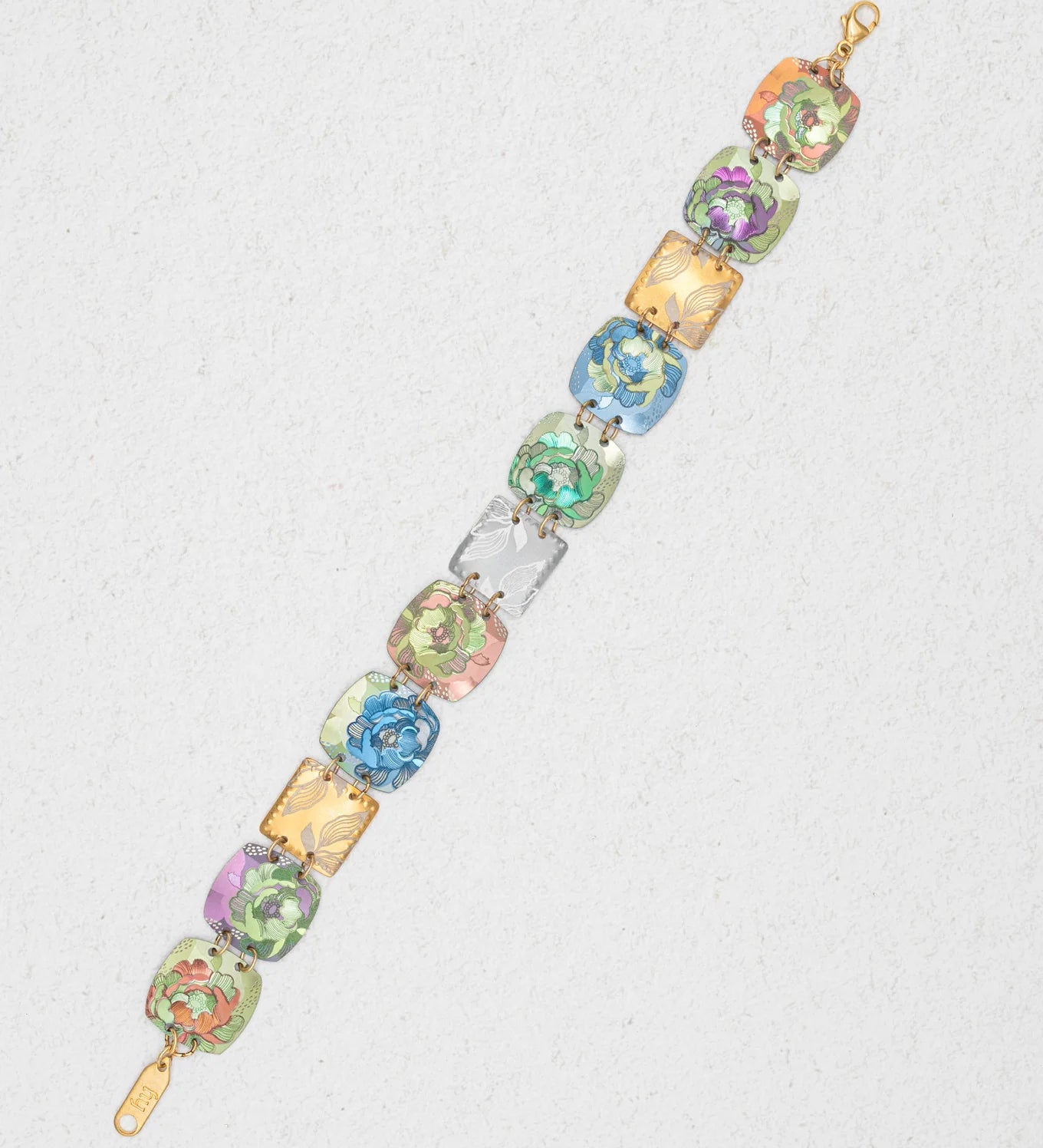 The Flora Multi Color Earrings by Holly Yashi feature vibrant green, blue, pink, yellow, and purple floral designs on gold-tone links—a striking piece of niobium jewelry displayed on a light textured background.