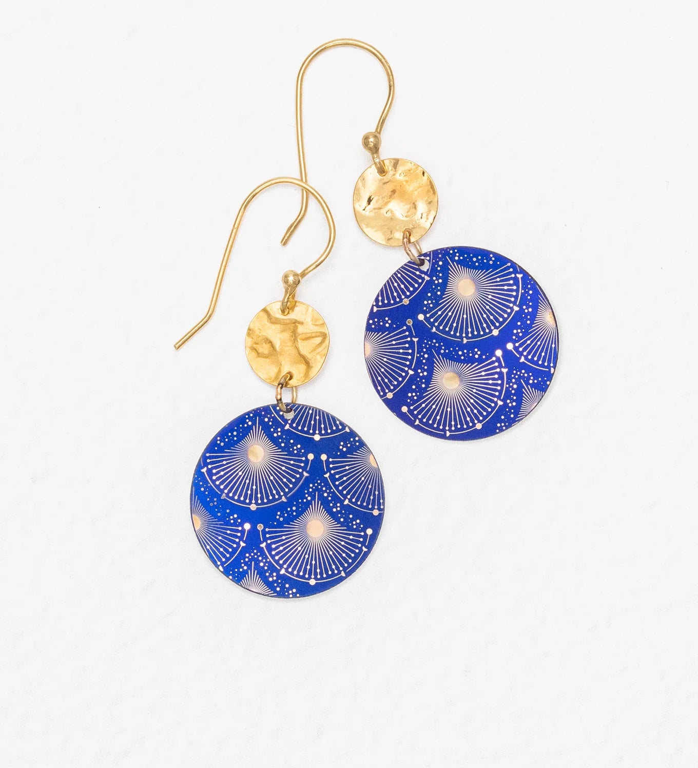 The Danica Earrings in Midnight Blue by Holly Yashi feature handcrafted dangle design with hammered gold circular tops and larger blue round pendants accented by a decorative white and gold fan pattern. Displayed on a white background, these Niobium earrings offer unique style.