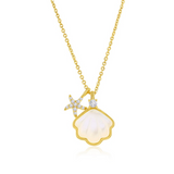 The Classic of New York Gold Plated Mother of Pearl Scallop Shell w/CZ Starfish features a gold-trimmed mother of pearl shell and a gemstone-encrusted starfish charm on a delicate gold chain.