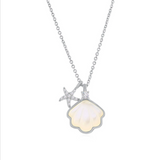 The Classic of New York Sterling Silver & Mother of Pearl Scallop Shell Necklace features a delicate chain, a shell-shaped pendant with a luminous center, and a CZ starfish accent—a stunning accessory for any occasion.