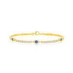 The Gold Plated CZ Evil Eye Tennis Bracelet by Classic of New York features a central blue gemstone, clear and blue accent stones, and a slim, elegant band with a clasp closure.