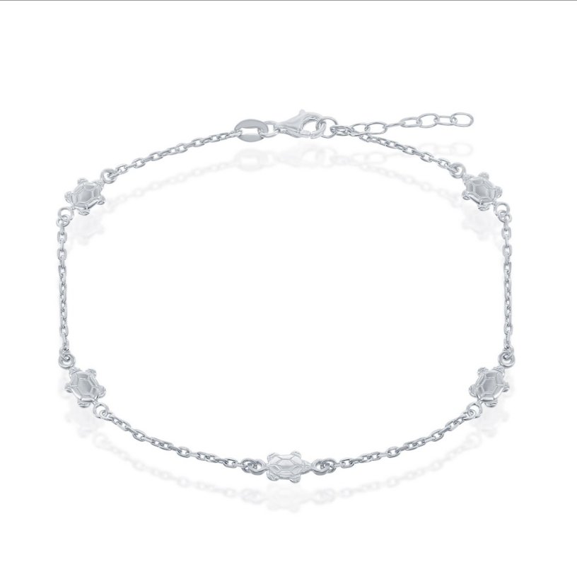 The Sterling Silver Turtle Anklet by Classic of New York features small turtle-shaped links on a thin 925 sterling silver chain with an adjustable clasp.
