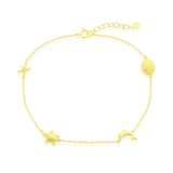 The Classic of New York Gold Plated Shell/Dolphin/Turtle/Starfish Anklet features ocean-inspired charms on a fine adjustable chain, perfect for adding a delicate beach touch to any outfit.