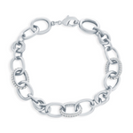 The Classic of New York Sterling Silver Micro Pave CZ & Polished Oval Bracelet features large oval links, some embellished with micro pave CZ stones, and is secured with a lobster clasp.