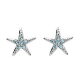 The Swarovski Crystals Aqua Starfish Stud Earrings by Shanore feature elegant five-pointed stars adorned with small round blue crystals and a silver-toned finish, capturing the sparkling allure of shimmering waters.