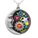 Introducing the Midnight Moon Multi-Color Necklace by Firefly Jewelry. Handmade in Guatemala, this exquisite piece features a silver crescent moon with a face on the left, vibrant gemstones, including a star and red gem, set on a black background with a rope-like border.