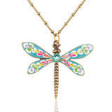The Brite Bloom Cascade Bouquet Small Dragonfly Crystal Necklace by Anne Koplik Designs, Inc. features a gold chain, blue wings with multicolored floral designs, a green gem center, and an antiqued brass body for vintage-inspired charm.