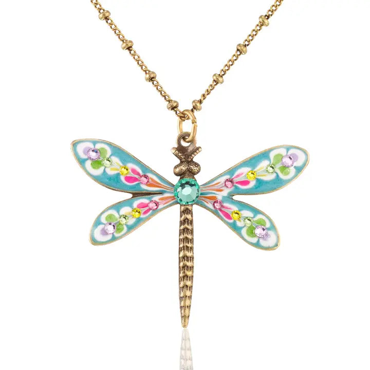 The Brite Bloom Cascade Bouquet Small Dragonfly Crystal Necklace by Anne Koplik Designs, Inc. features a gold chain, blue wings with multicolored floral designs, a green gem center, and an antiqued brass body for vintage-inspired charm.