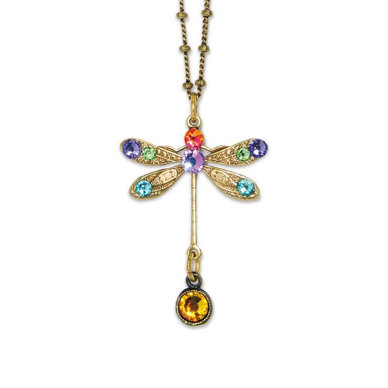 The Stone Dragonfly w/Drop Necklace by Anne Koplik Designs, Inc. features a gold dragonfly pendant with red, purple, green, and blue gemstones on antiqued brass and a round amber drop.