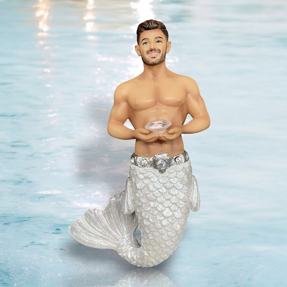 The April Birthstone-Diamond Merman by December Diamonds is a hand-painted figurine with a shiny silver tail, muscular build, light skin, and short brown hair holding a seashell—ideal for holiday decor or as a unique collectible.
