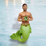 The August Birthstone-Peridot Merman by December Diamonds features a merman with a green tail holding a peridot gem, set against water. He wears a jeweled belt with short brown hair and a trimmed beard—perfect for August birthdays.