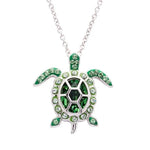 The Shanore Swarovski Crystals August Birthstone Turtle Necklace features a sterling silver turtle pendant with green and black Swarovski crystals, elegantly hanging from a delicate chain, adding sophistication to any outfit.