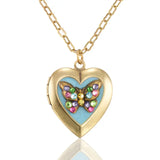 The Butterfly Heart Shaped Locket Pendant Crystal Necklace by Anne Koplik Designs features a jeweled butterfly on a turquoise enameled blue heart, making it a stunning photo keepsake.