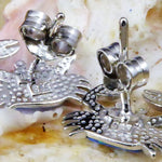 The Jewelry Network Caribbean Opal Crab Post Earrings feature detailed claws and textured shells, displayed on a seashell background with visible earring backs.
