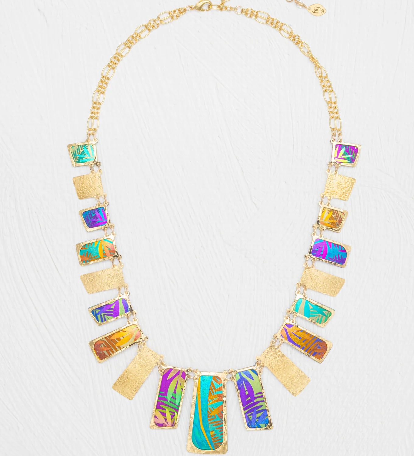 Introducing the Mahana Multi 19 Rectangular Drops Necklace by Holly Yashi: a stunning gold niobium necklace featuring alternating rectangular pendants with textured gold and colorful iridescent patterns, arranged in a symmetrical design. This unique piece of tropical jewelry effortlessly captures vibrant elegance and island-inspired style.