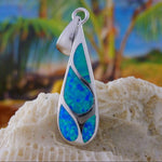 The Caribbean Opal Teardrop 4 Segments Pendant ONLY by Jewelry Network features shimmering blue-green opal inlays, displayed on coral with a tropical backdrop of palm trees and sky.