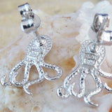 The Caribbean Opal Octopus Post Earrings by Jewelry Network, crafted from 925 Sterling Silver with textured detailing, are displayed on a light-colored seashell background.