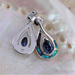Jewelry Network’s Caribbean Opal 4 Segment Teardrop/Tanzanite CZ Post Earrings feature blue gemstone centers and green-blue accents, shown on a lustrous pearlescent shell background.
