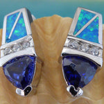 The Jewelry Network Caribbean Opal/CZ/Amethyst Point Earrings showcase blue-green opal inlays with geometric designs, a middle row of sparkling CZs, and amethyst triangles at the bottom, all displayed on a seashell.