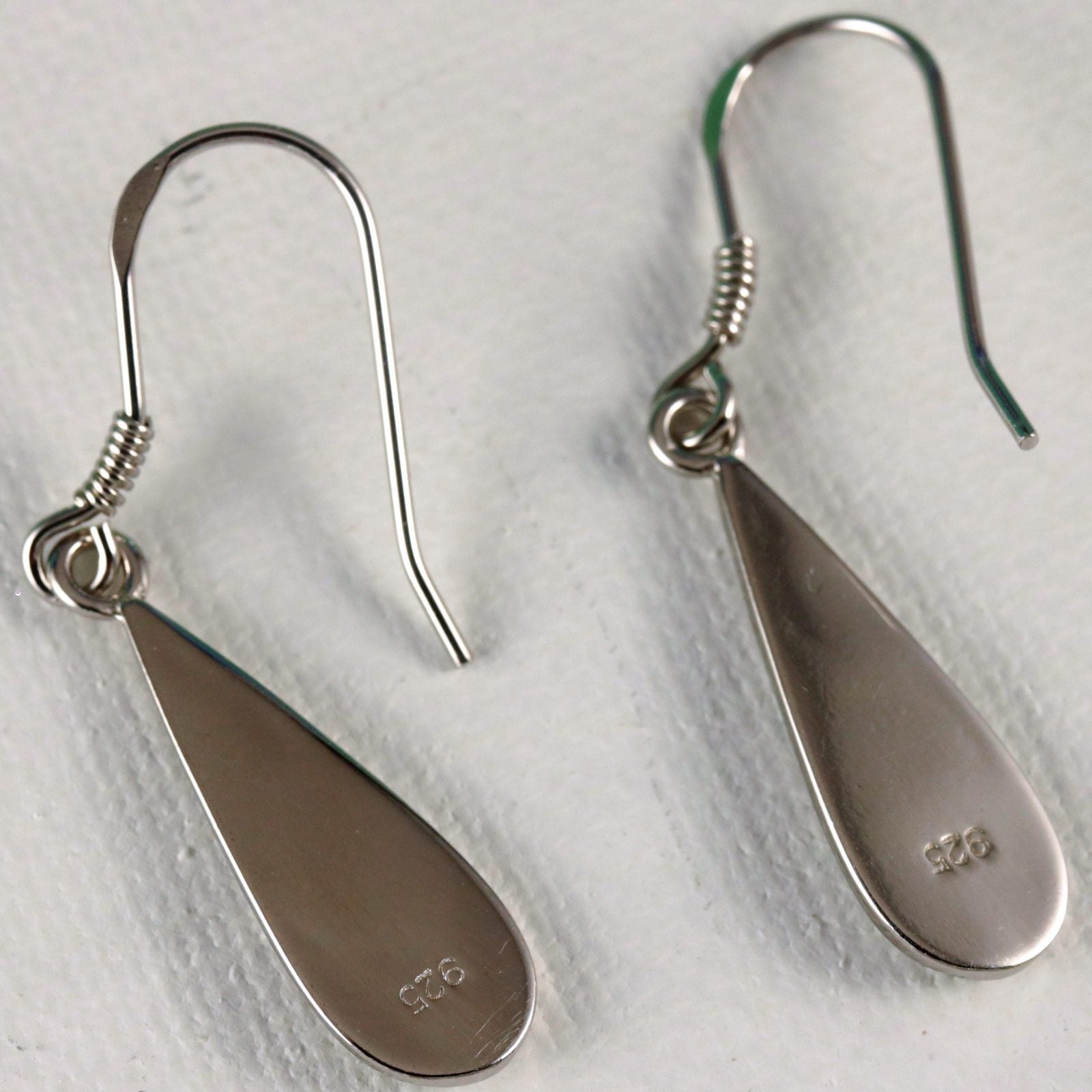 Jewelry Network’s Caribbean Opal Teardrop 4 Segment Earrings feature silver 925-stamped teardrop dangles with hook backs, shown on a white textured surface.