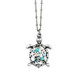 The Multi Stone Turtle Turquoise Necklace by Anne Koplik Designs, Inc. features a sterling silver turtle pendant with blue and clear gemstone accents on a beaded chain, evoking the style of classic turquoise jewelry.